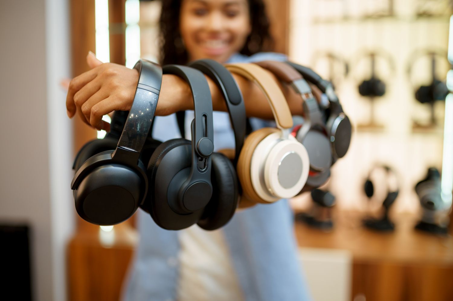 woman holding bluetooth headphones